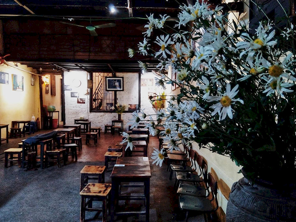 The cafe offers a cozy and nostalgic atmosphere, providing patrons with a glimpse into Hanoi's rich cultural heritage